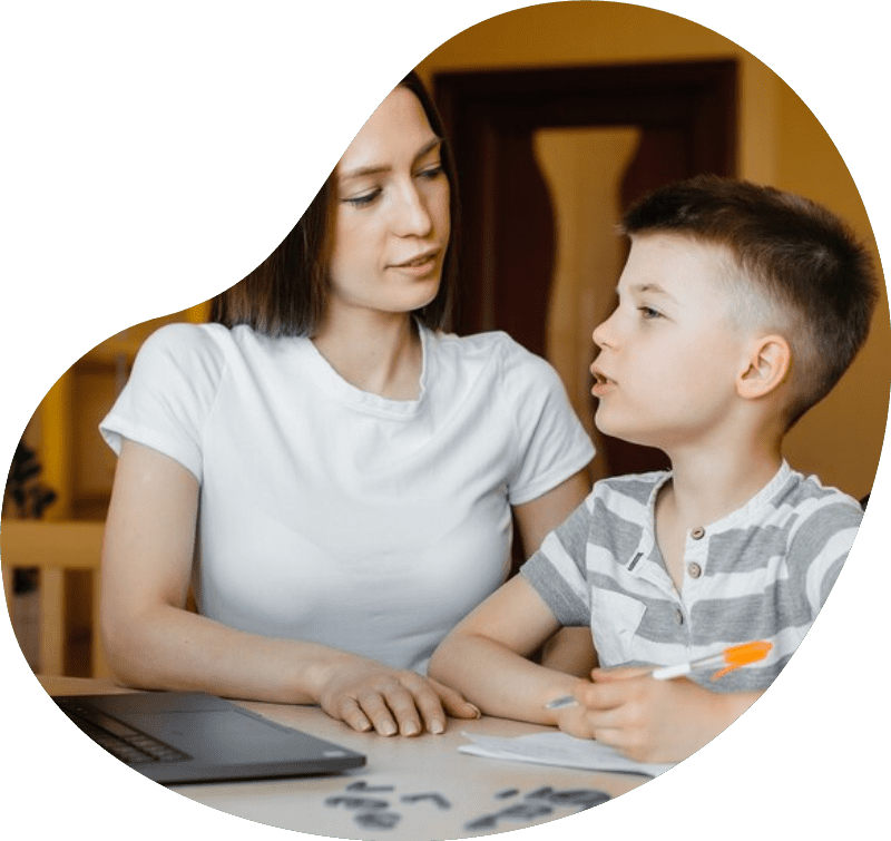 A mother and her child are engaged in distance learning at home in front of the computer