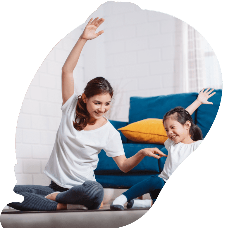 Mother and daughter exercising together happily at home