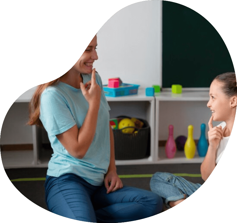 Psychologist helping a little girl in speech therapy